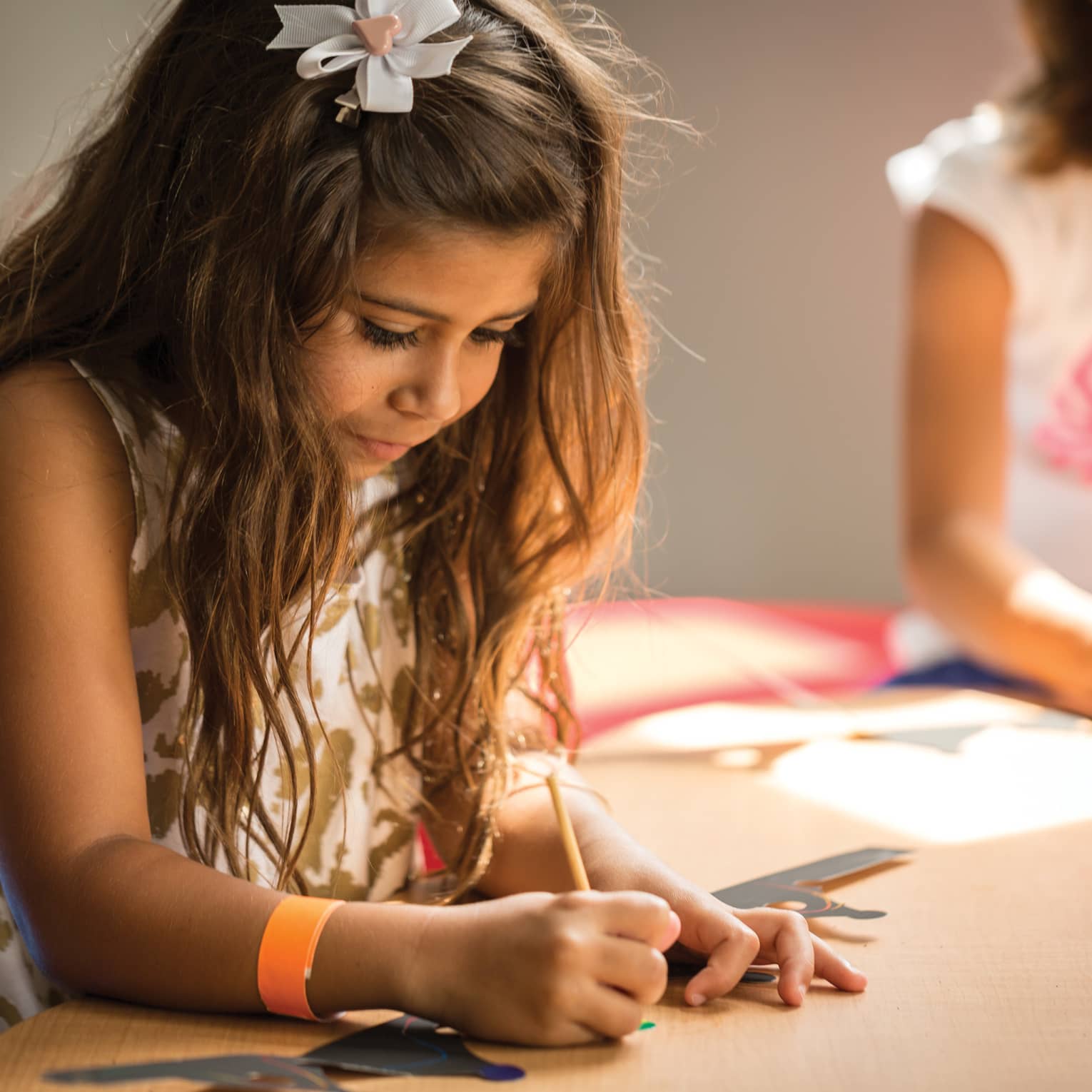 Young girl colours picture in Kids Centre
