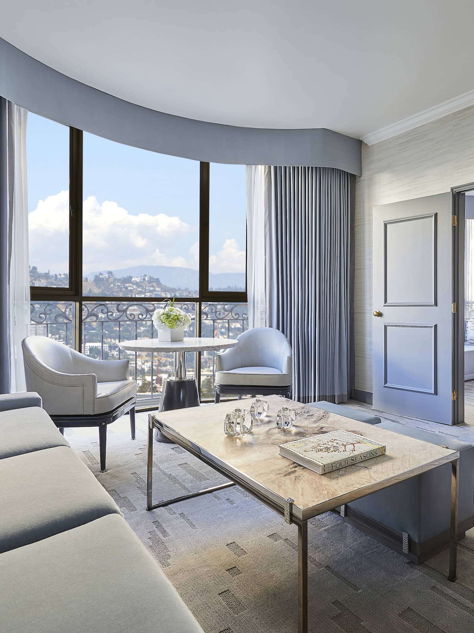 Hotel suite living room with sliding doors to bedroom