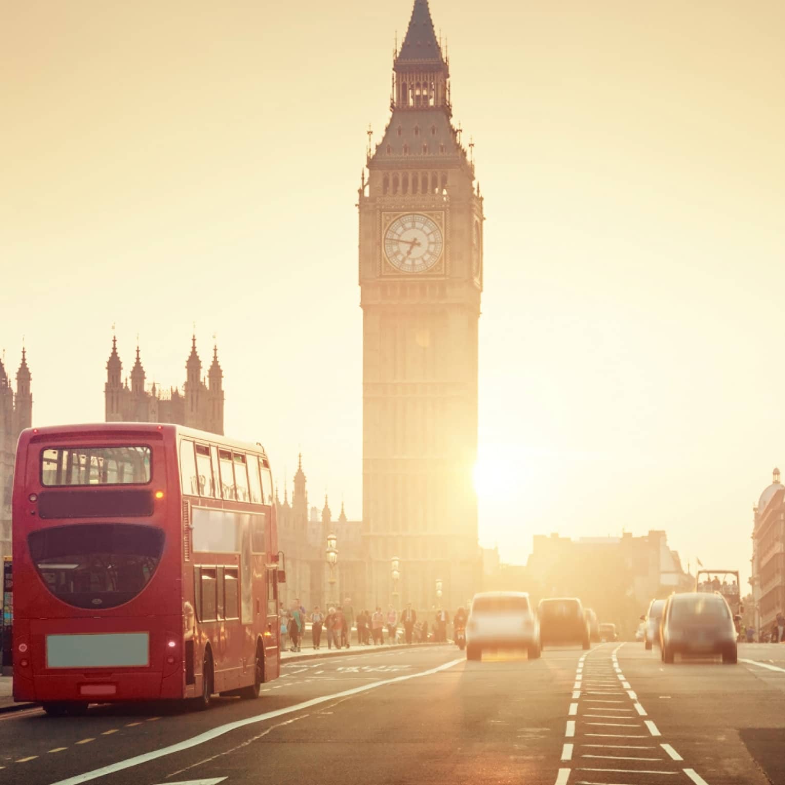 Street view of London at sunset, Big Ben tower and red double-decker bus in background