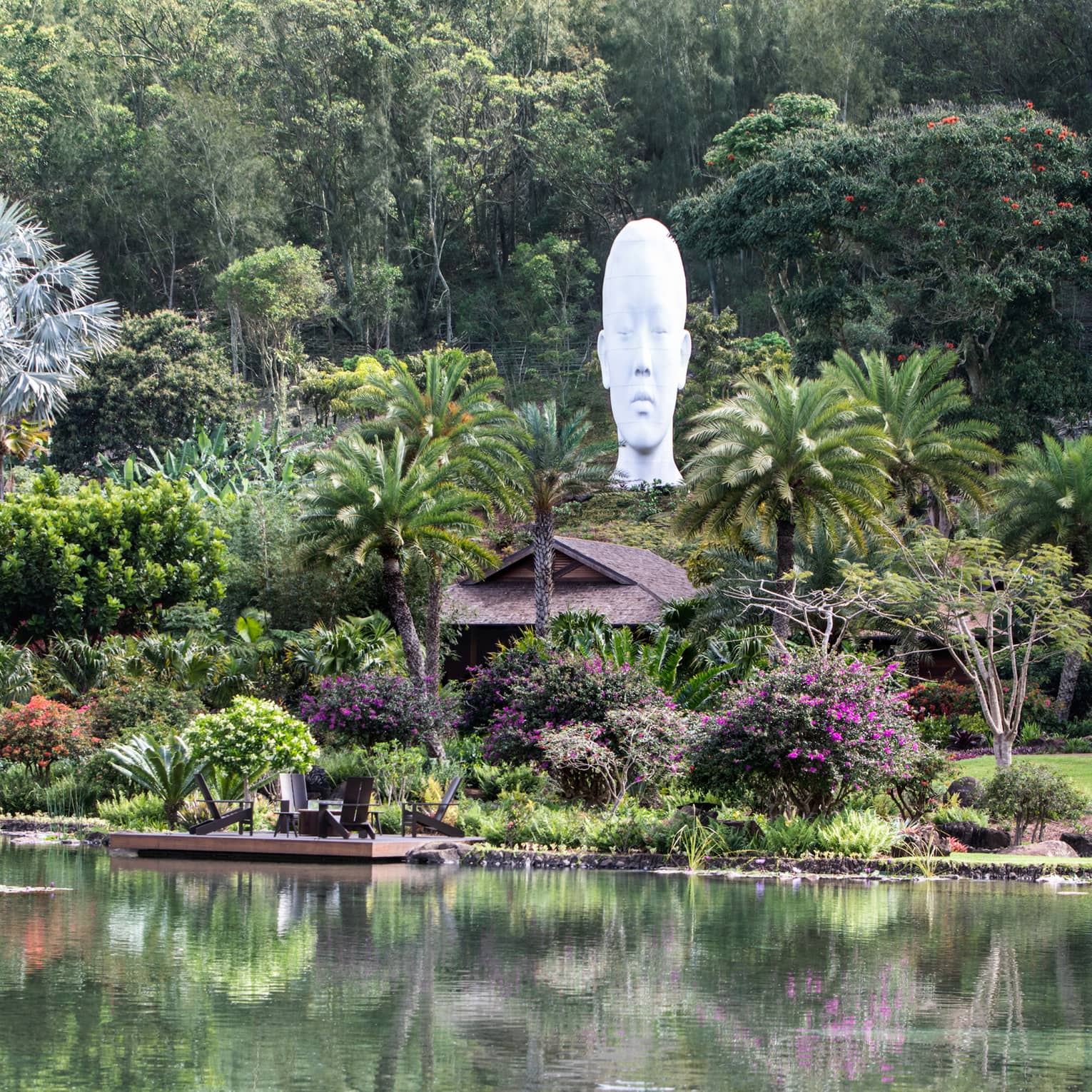 Lush tropical grounds of resort with sculpture head