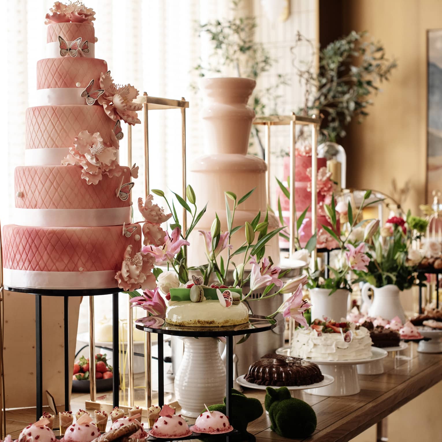 A buffet with cakes, cupcakes and desserts