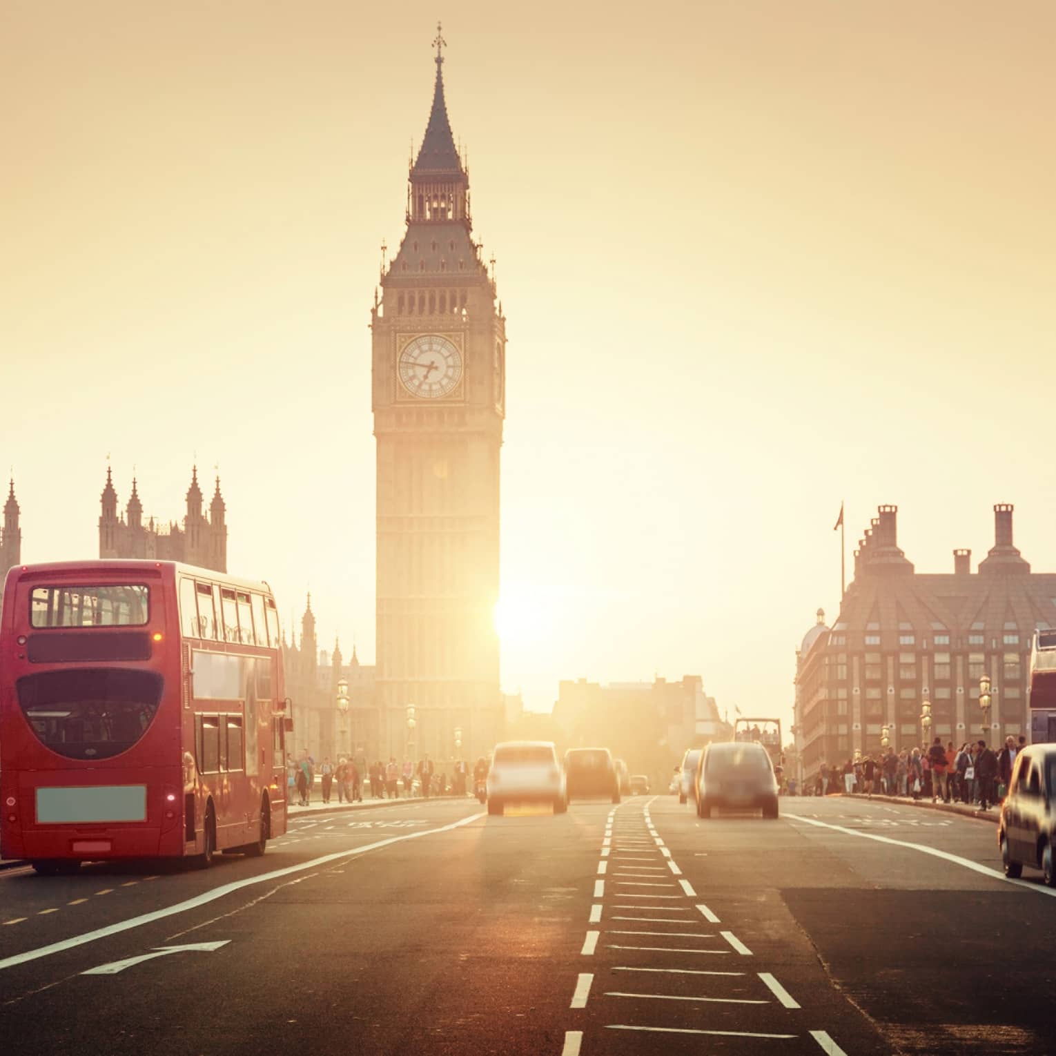 Street view of London at sunset, Big Ben tower and red double-decker bus in background