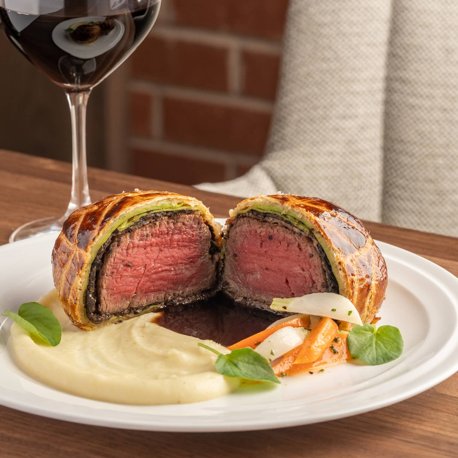 Beef Wellington with potato puree, glass of red wine