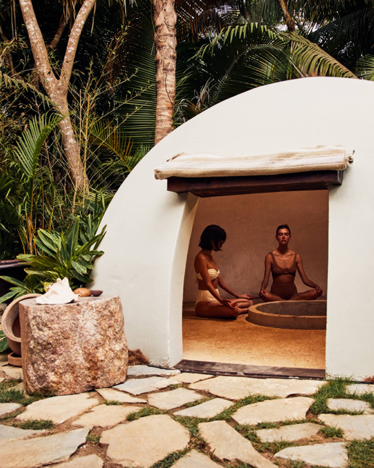 A heated dome shaped room surrounded by trees.