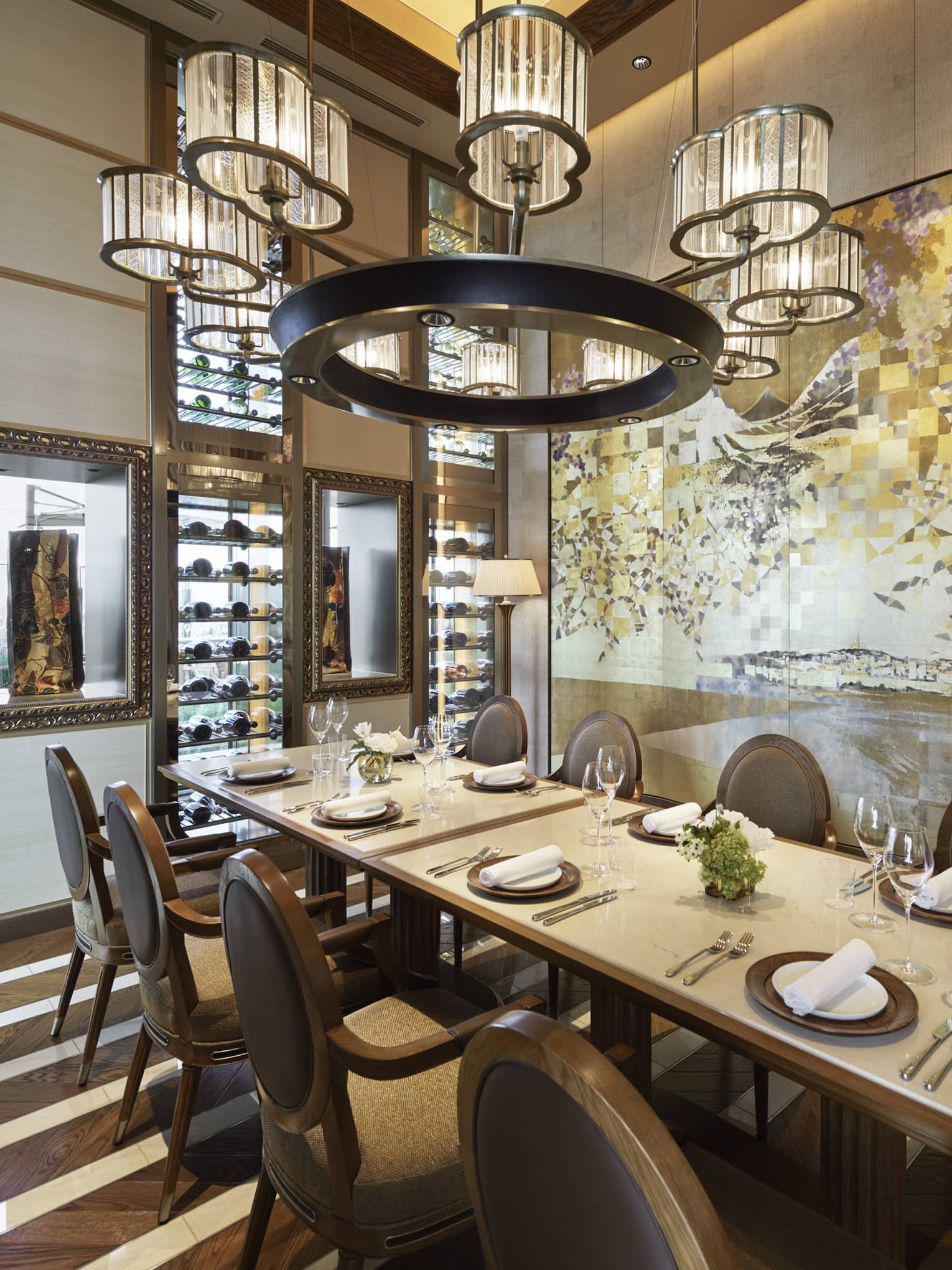 Est dining room with table set for eight, muted cream decor, circular chandelier, hardwood floors