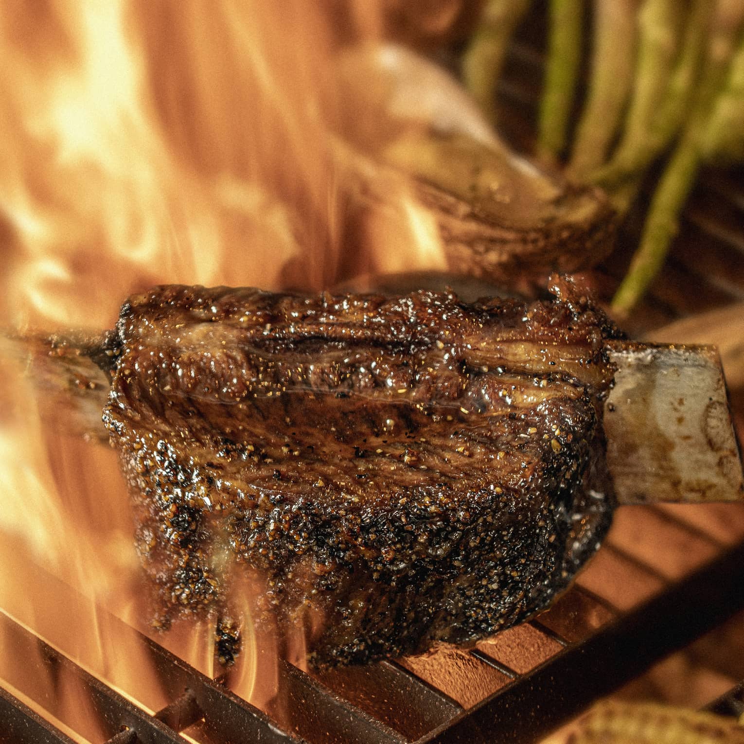 Close-up of chargrilled steak, asparagus and corn on grill grates