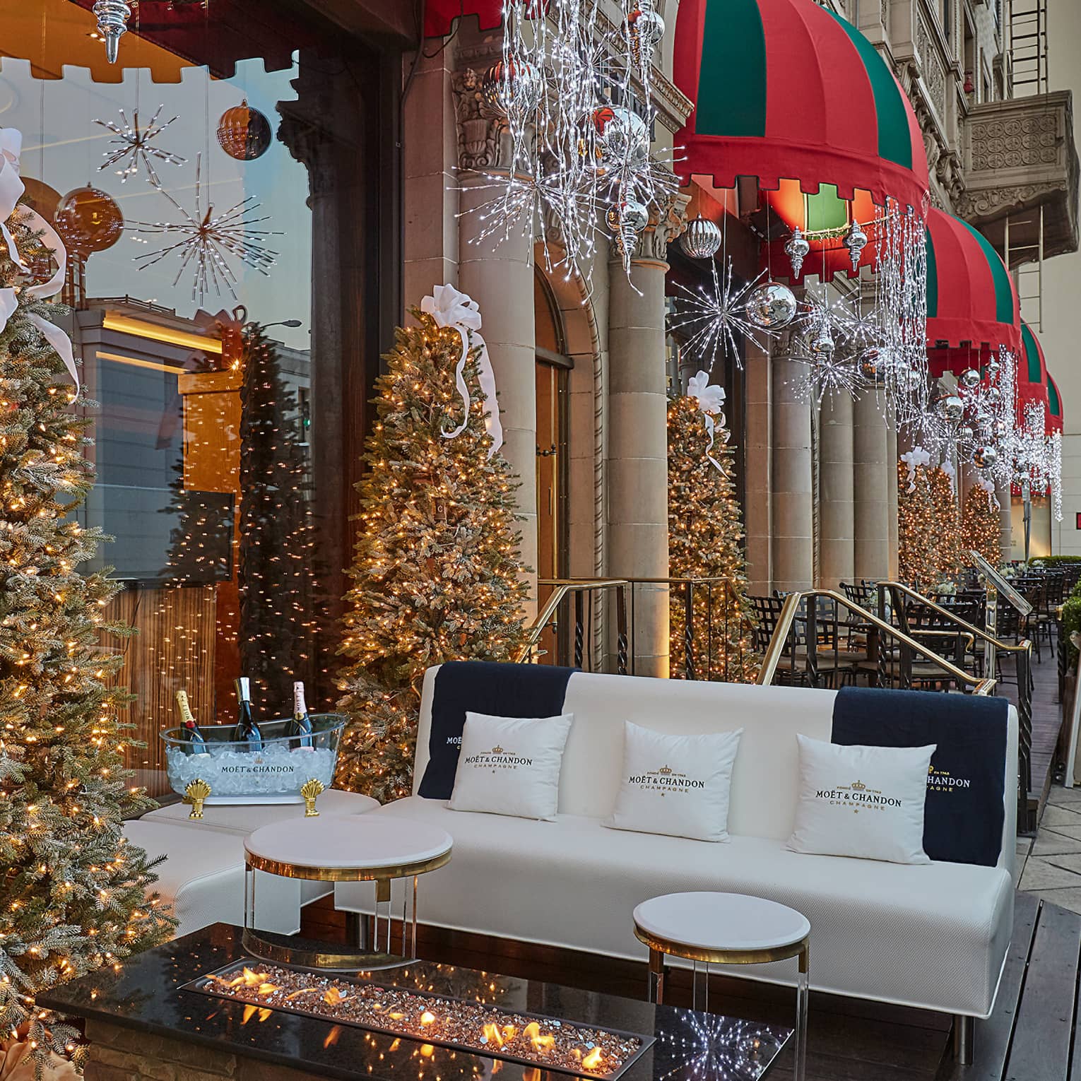 Hotel's sidewalk patio decorated with Christmas trees and lights