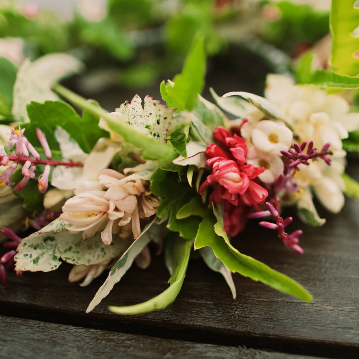 Tropical flowers arranged in floral wedding crown on table