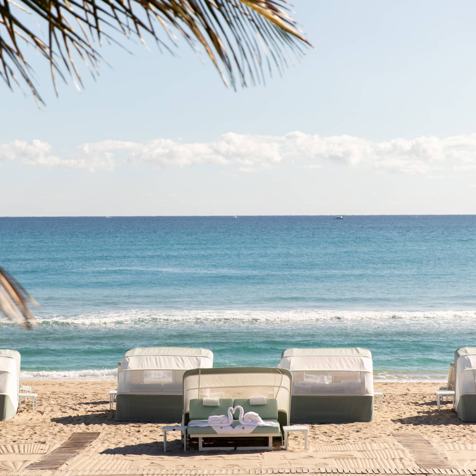 Five beachfront cabanas look out onto the ocean