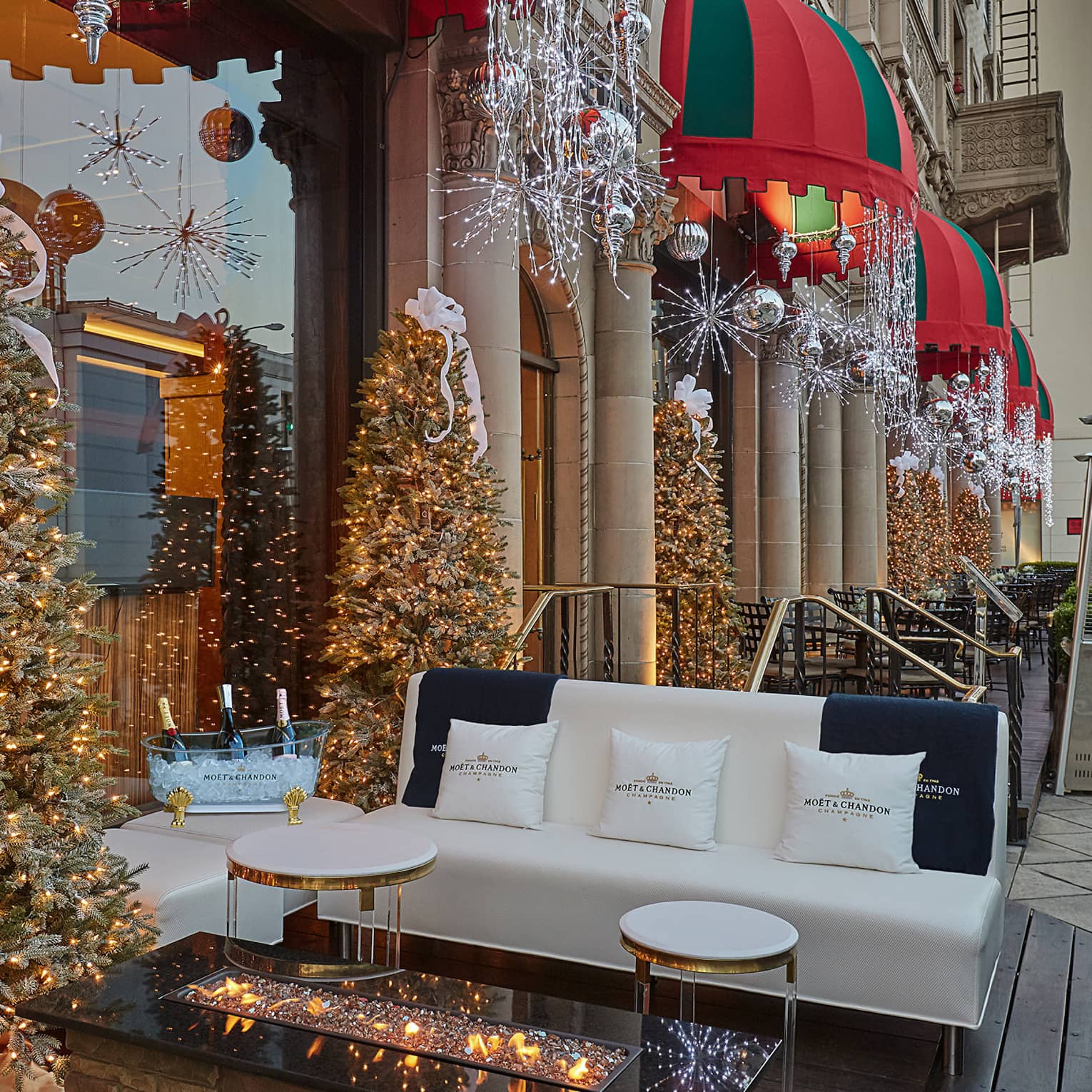Hotel's sidewalk patio decorated with Christmas trees and lights