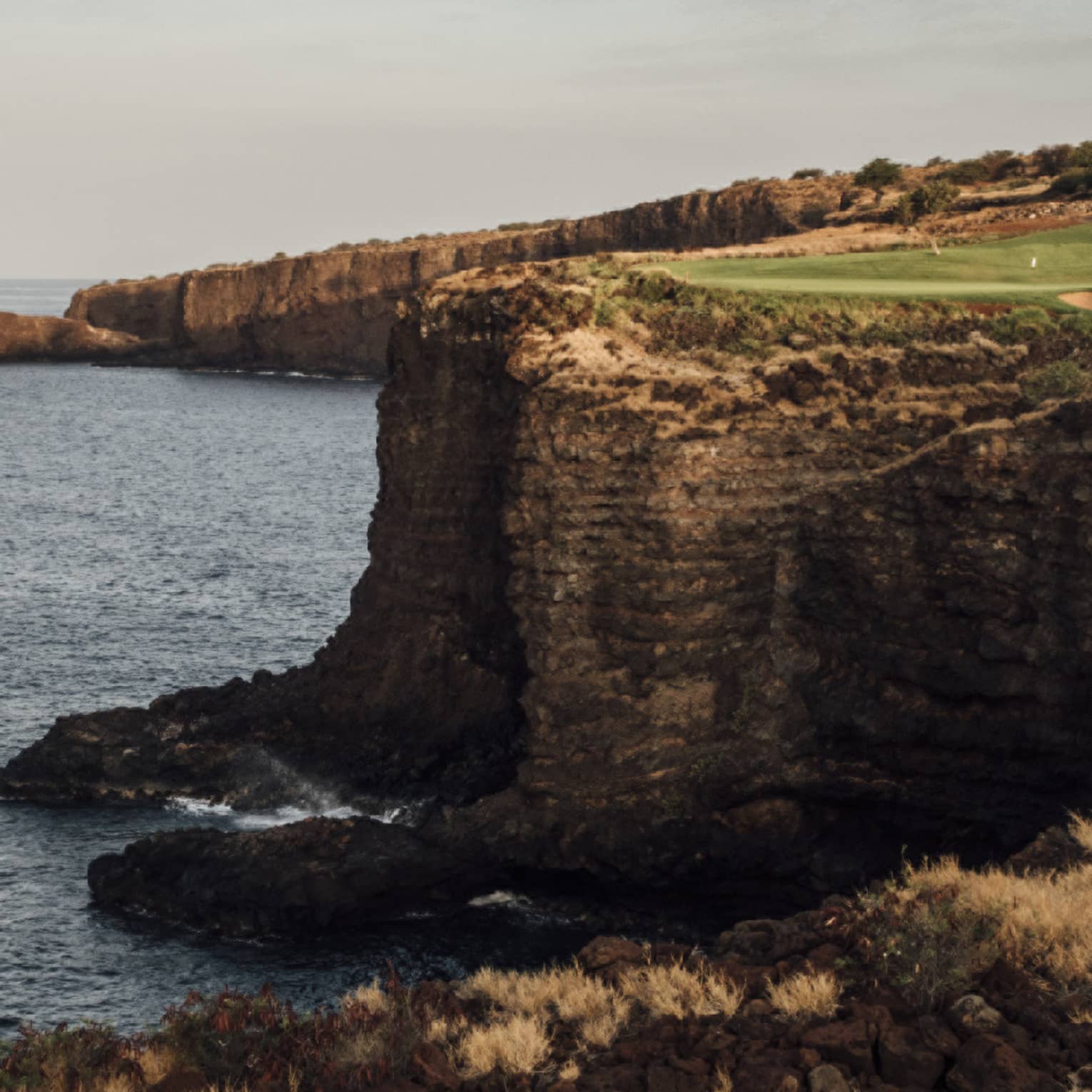 Golf course at Four Seasons Resort Lanai, cliffside along the ocean