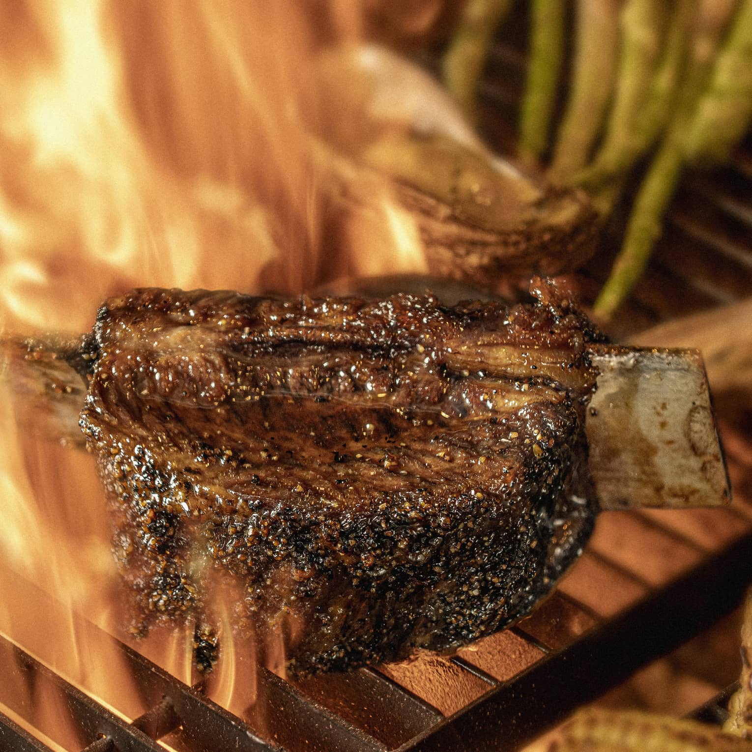 Close-up of chargrilled steak, asparagus and corn on grill grates