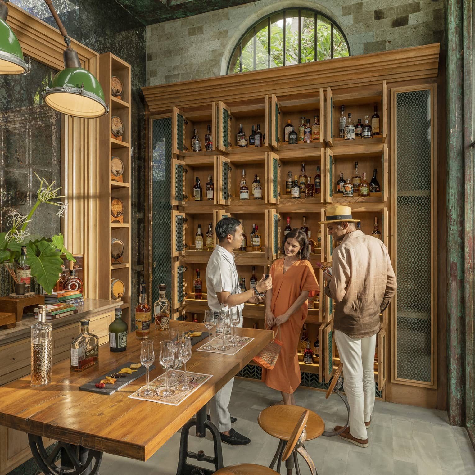 Male staff members offers samples to couple at Rum Vault