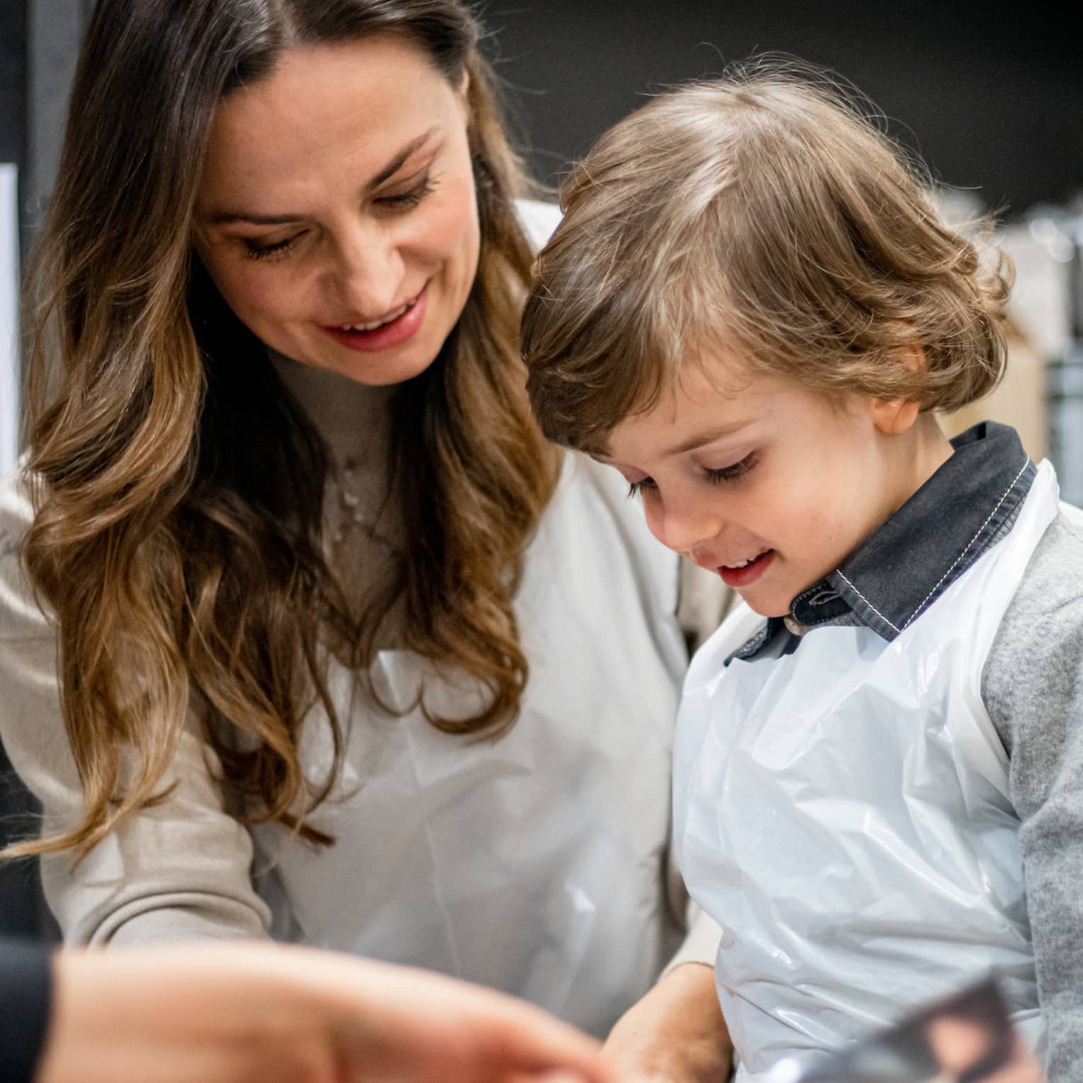 A family doing an activity in a kitchen.
