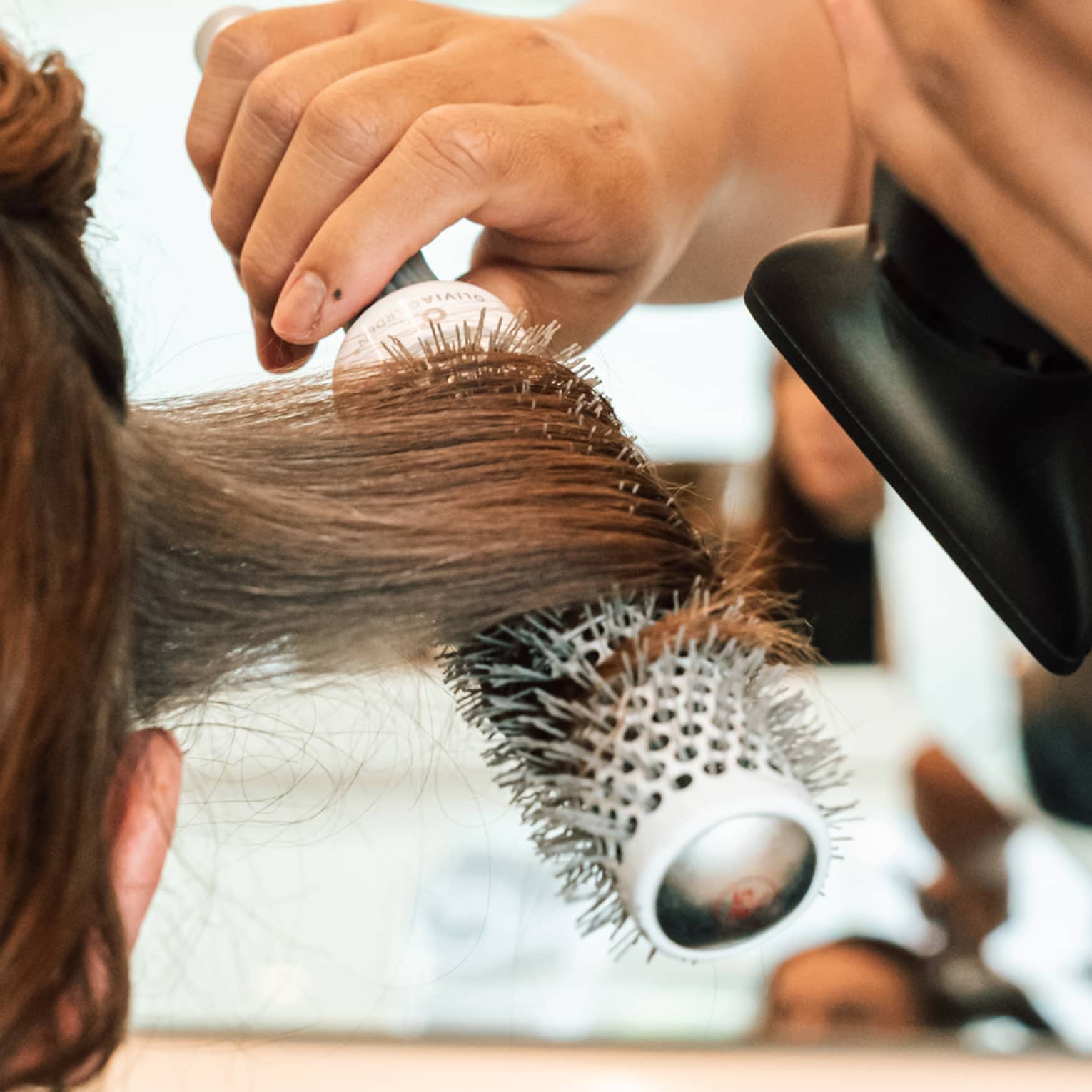 A person gets a blowout at hair salon