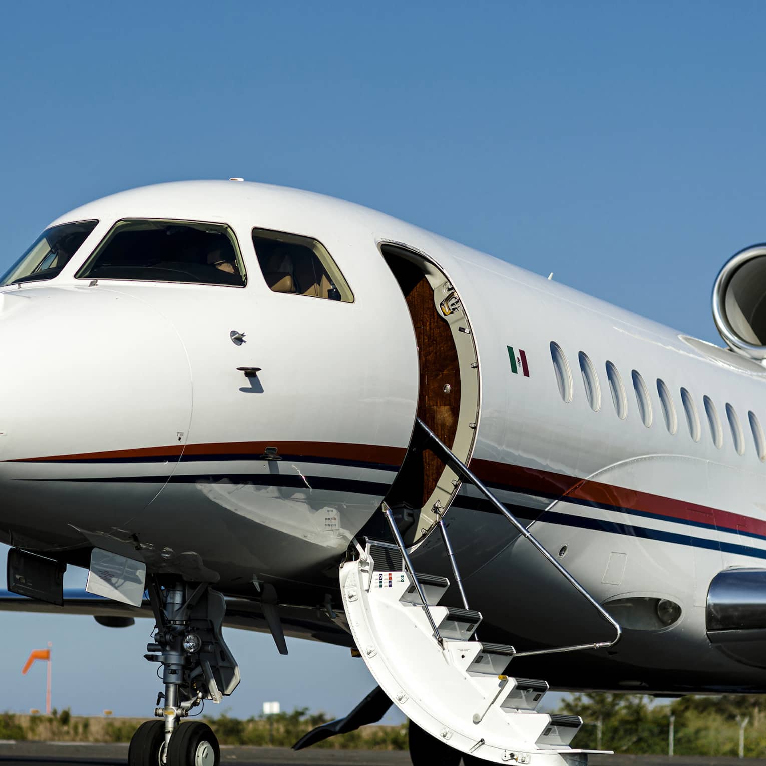 A jet on a runaway with a blue sky in the background