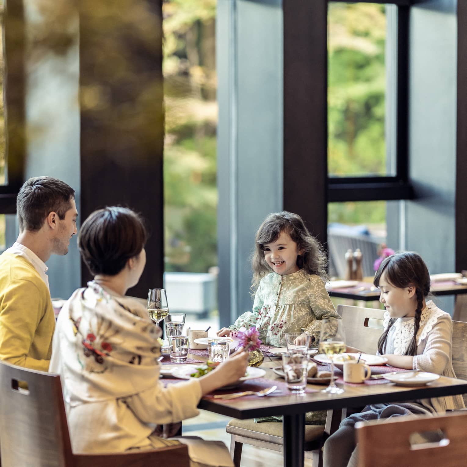 Parents and two young daughters share a meal at Brasserie