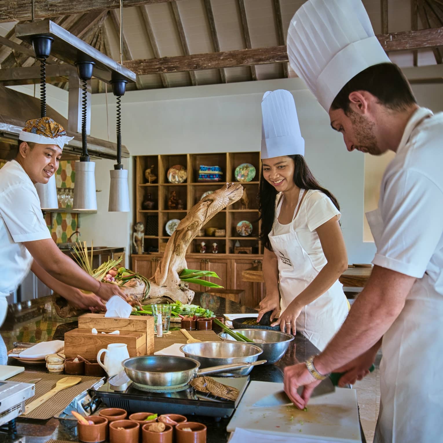 Two guests receive cooking lesson at Four Seasons hotel
