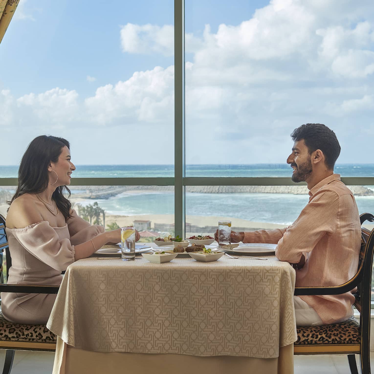 Couple enjoys a meal at Byblos Restaurant with views of the Mediterranean Sea