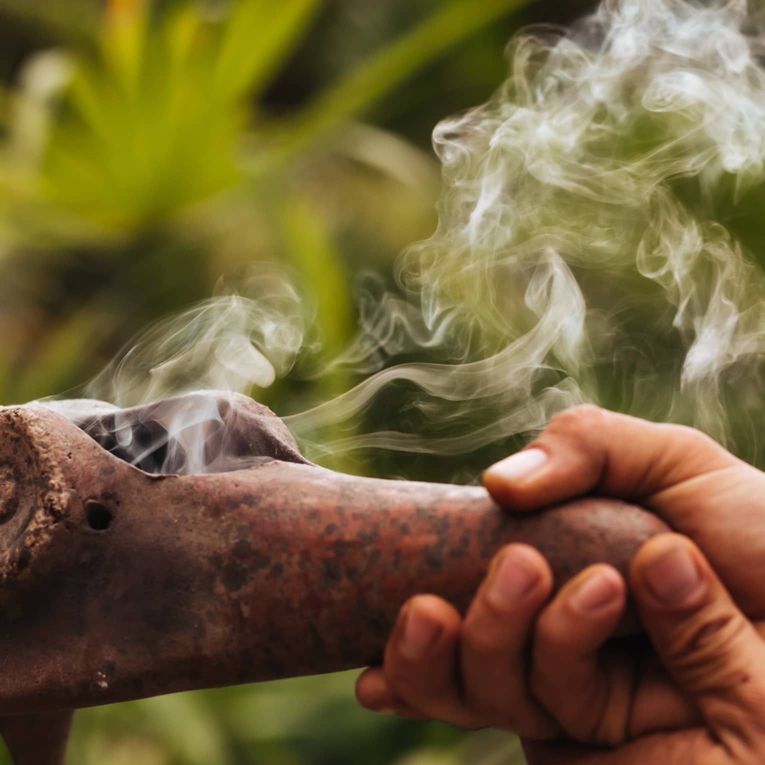 Smoke emerges from traditional Mayan copal pipe