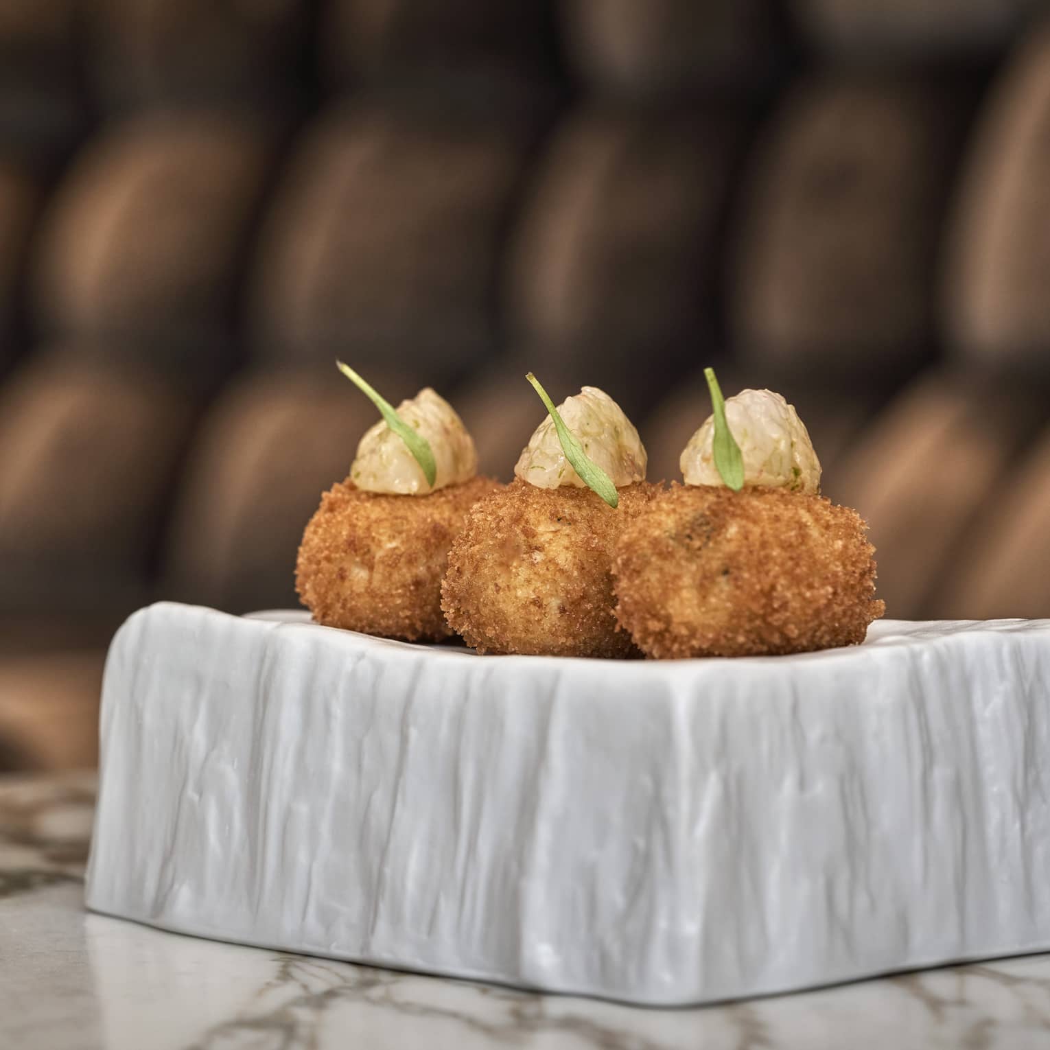 Three Free Range Chicken Croquettes with Red Shrimp on modern white plate