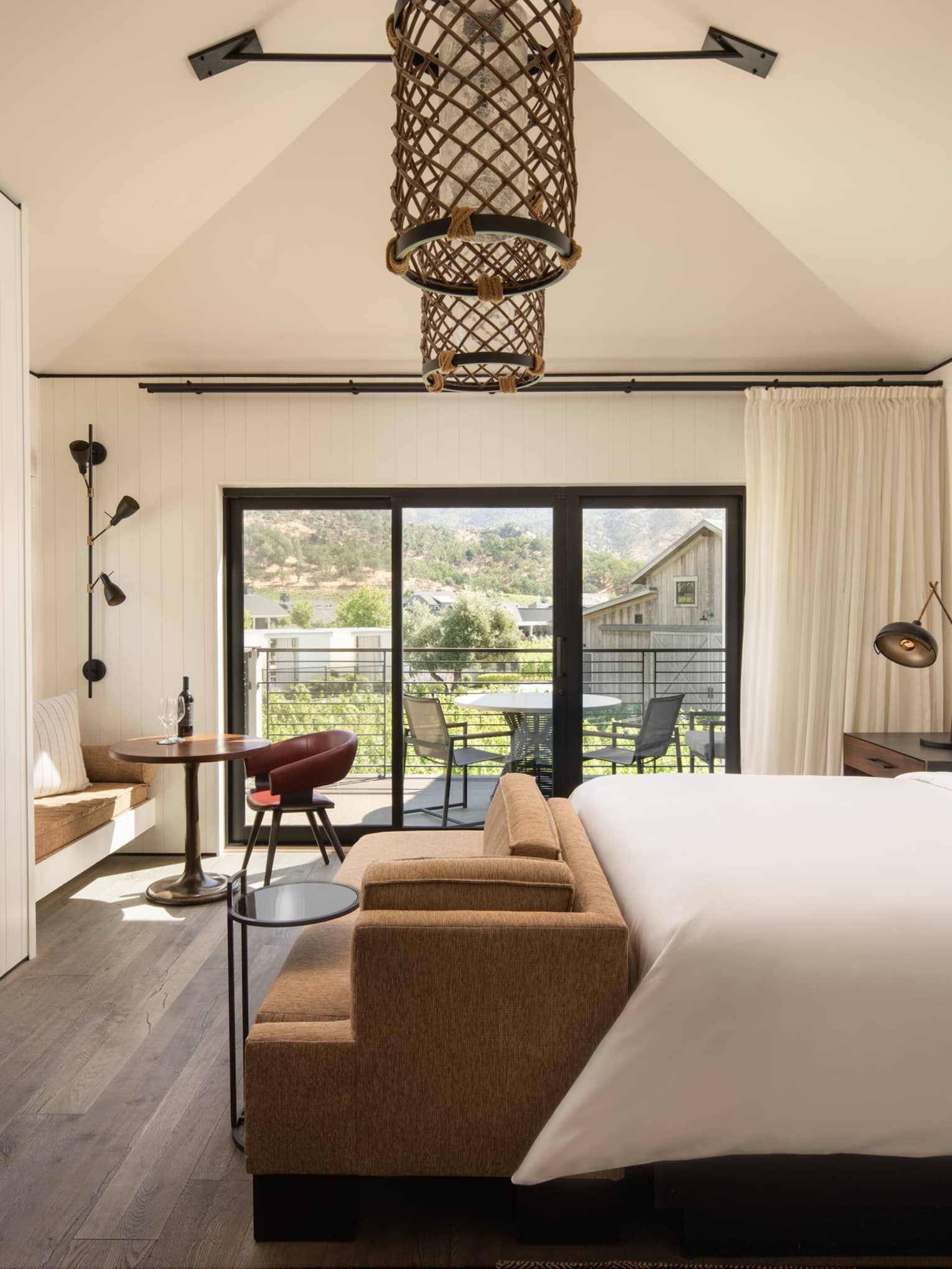 Contemporary king bed guest room at wine country resort