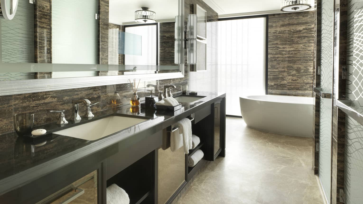 Premier Four Seasons Executive Suite large bathroom with double vanity sinks, glass shower, white soaker tub