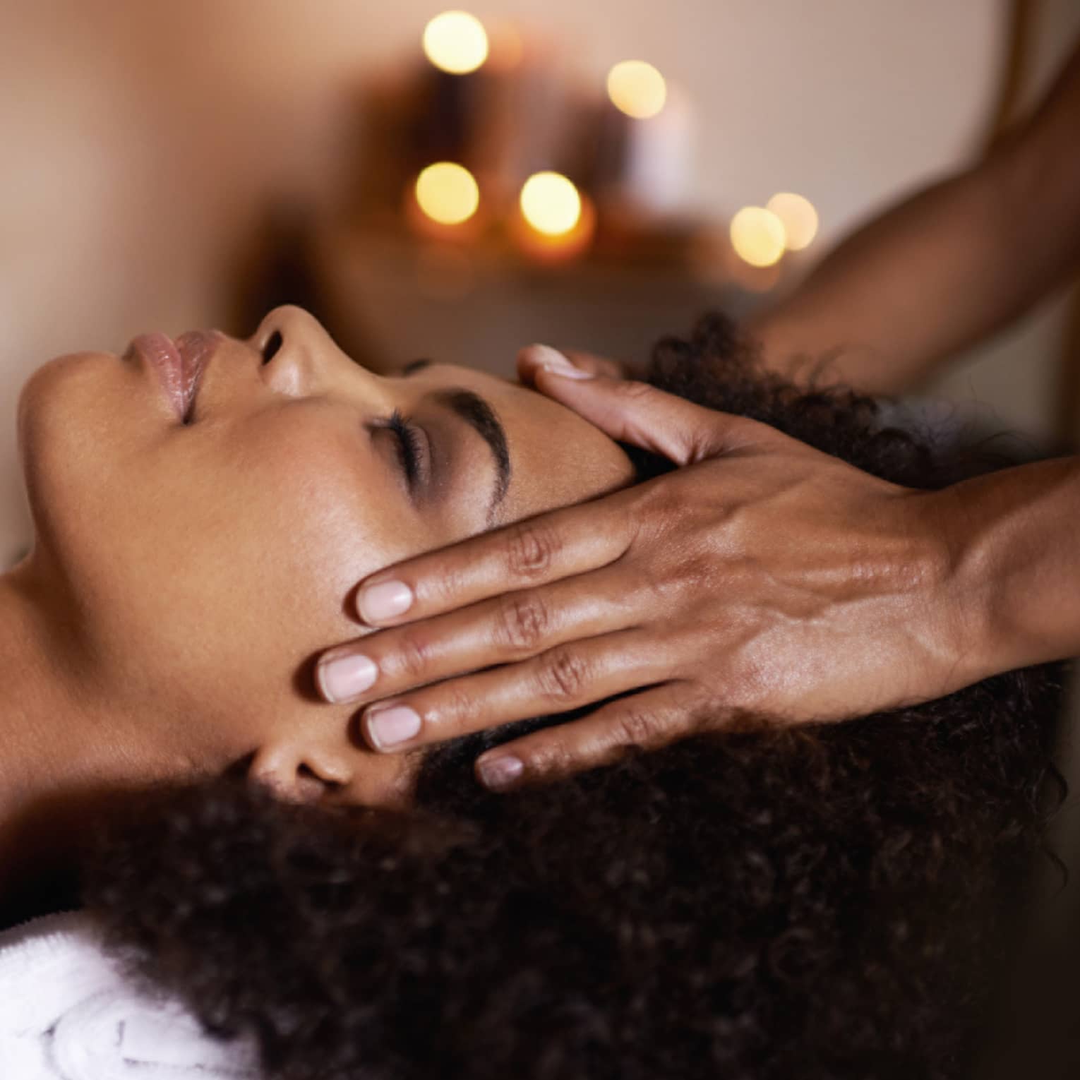 Woman laying down on massage bed getting a massage.