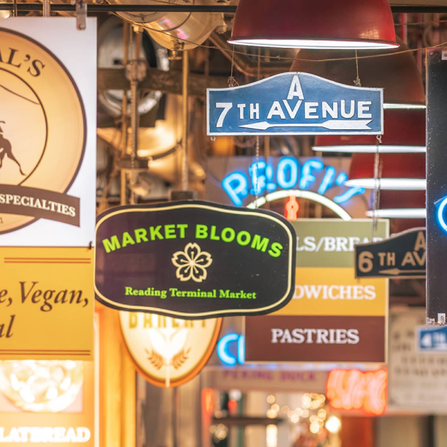 A busy street or alley with signs for food.