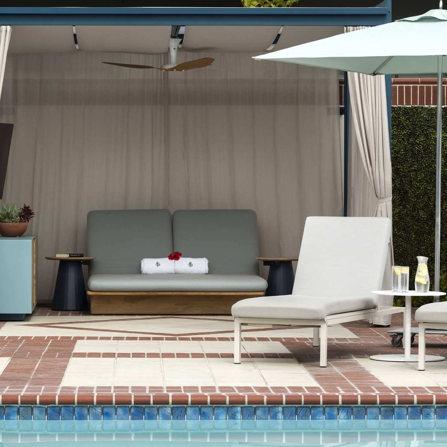 Pool with lounge chairs and umbrella, along with a canopy.