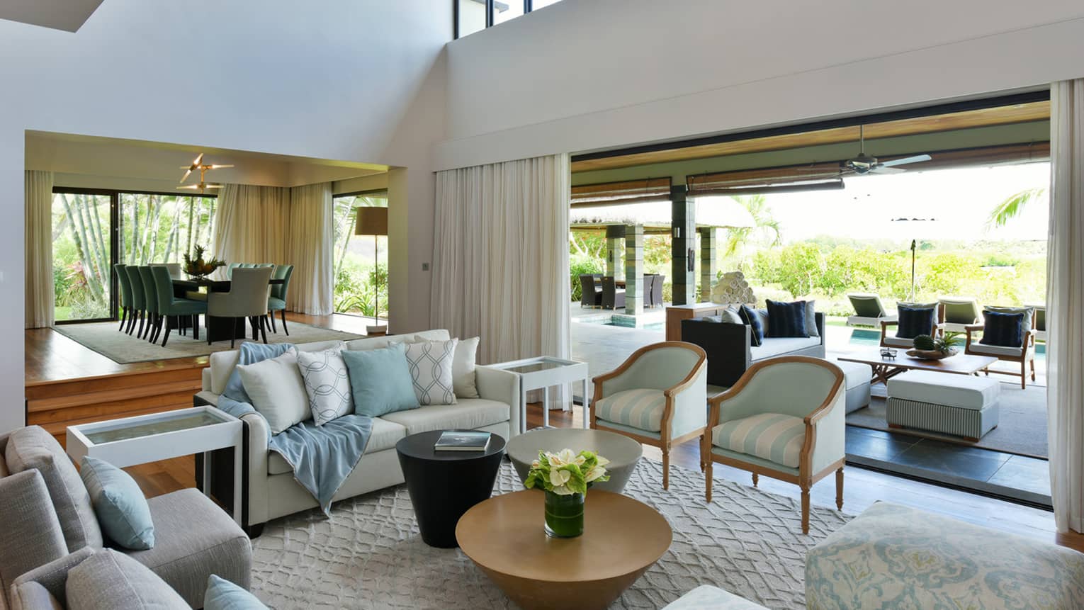 Royal Residence Villa modern living room with bright white-and-blue decor, raised dining room