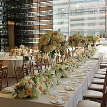 Elegant wedding dining table with rows of white and pink roses