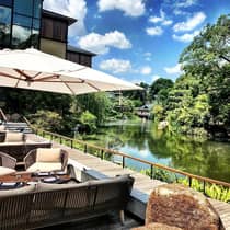 Blue sky with clouds over dining patio, water