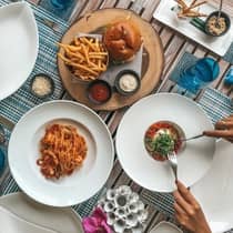 A guest enjoys a table full of various cuisine