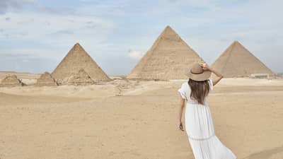 A guest wearing a linen dress observing the Great Pyramids