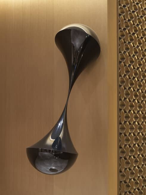 Black carbon fiber hourglass-shaped wall scultpure created by David Henderson