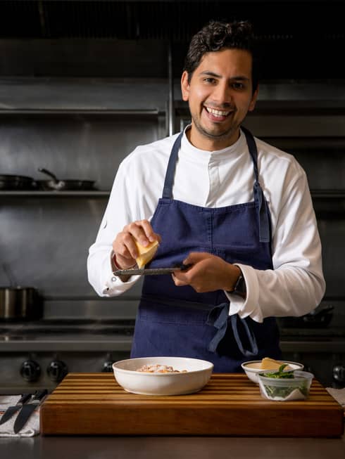 Chef Jesus Medina preps food in a kitchen