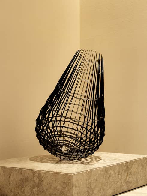 Tavizeh II by Sahand Hesamiyan, a cone-shaped metal sculpture on a marble plinth