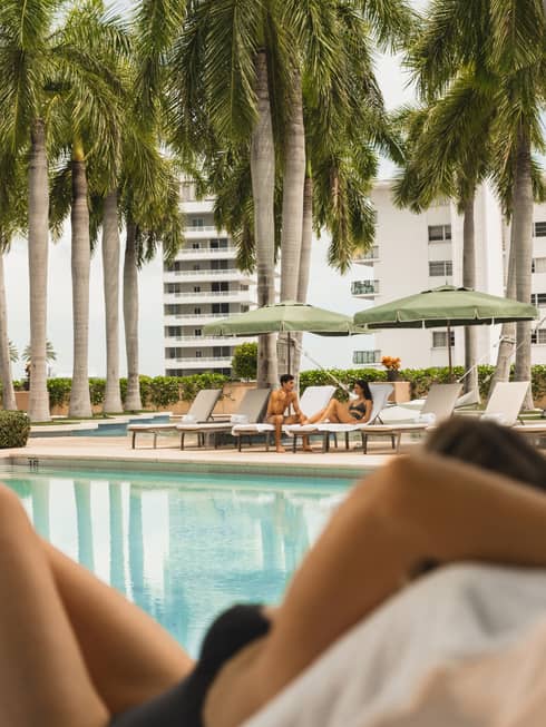 People lounging by a resort pool