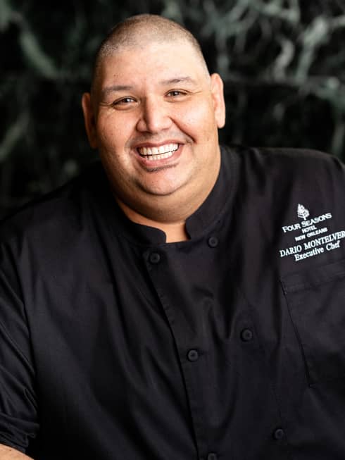 Chef Dario Montelvere smiling and wearing a chef?s coat