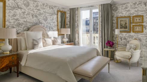 Grand Premier Suite bedroom with French wallpaper and king bed at Four Seasons Hotel George V, Paris