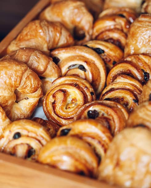 A display tray filled with rows of pastries of different types