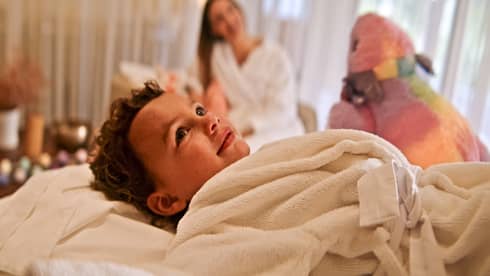 Child relaxes in a spa bathrobe