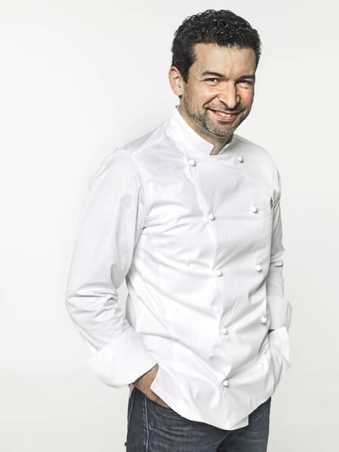 Head Baker Guillaume Cabrol in white chef?s coat, smiling and with hands in pockets
