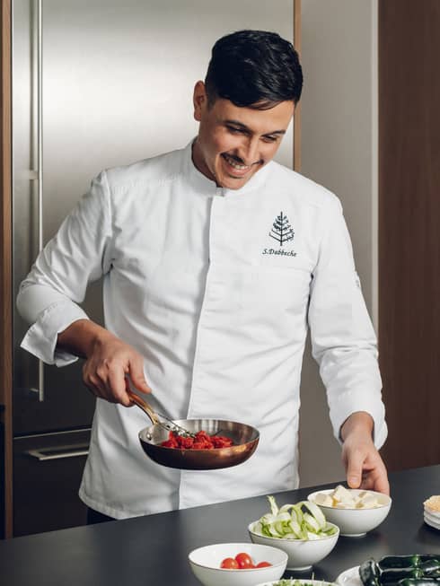Chef in a kitchen preparing a meal