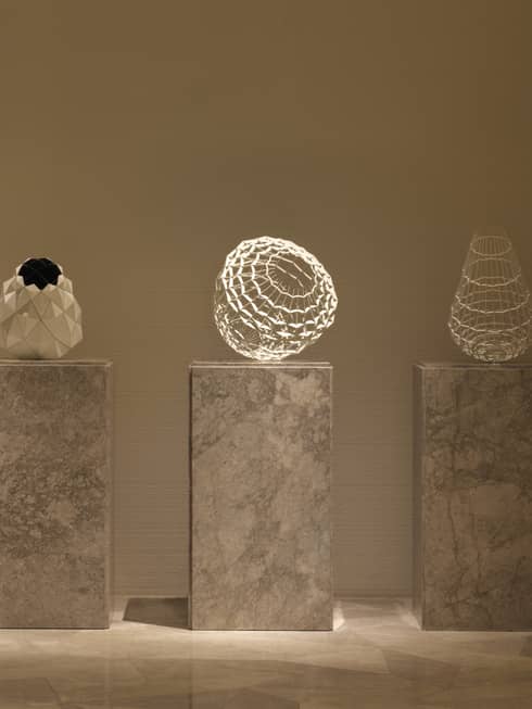 Three marble pillars with modern sculptures