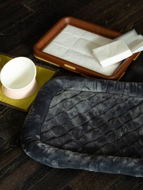 Pet bed and food and water bowls set out for four-legged Four Seasons guests