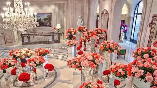 Beautiful pink and red flowers in large vases in luxury event space