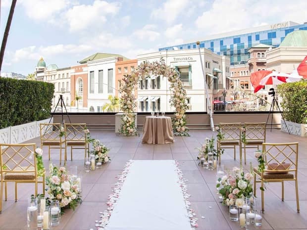 A rooftop wedding with colourful buildings in the background.