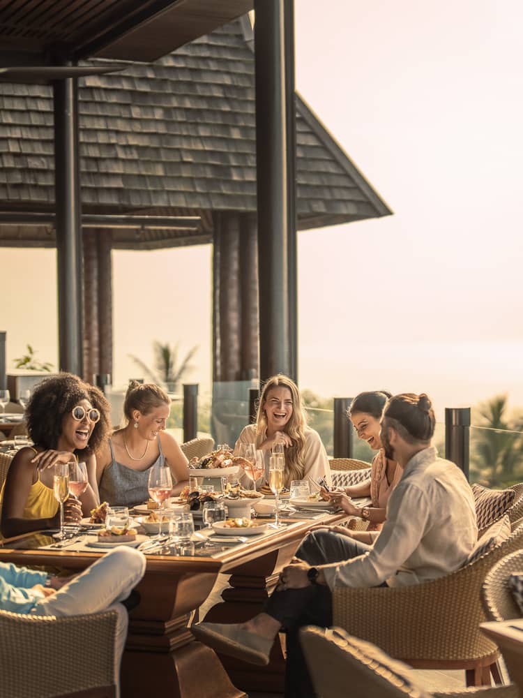Group of friends enjoys outdoor traditional Thai brunch